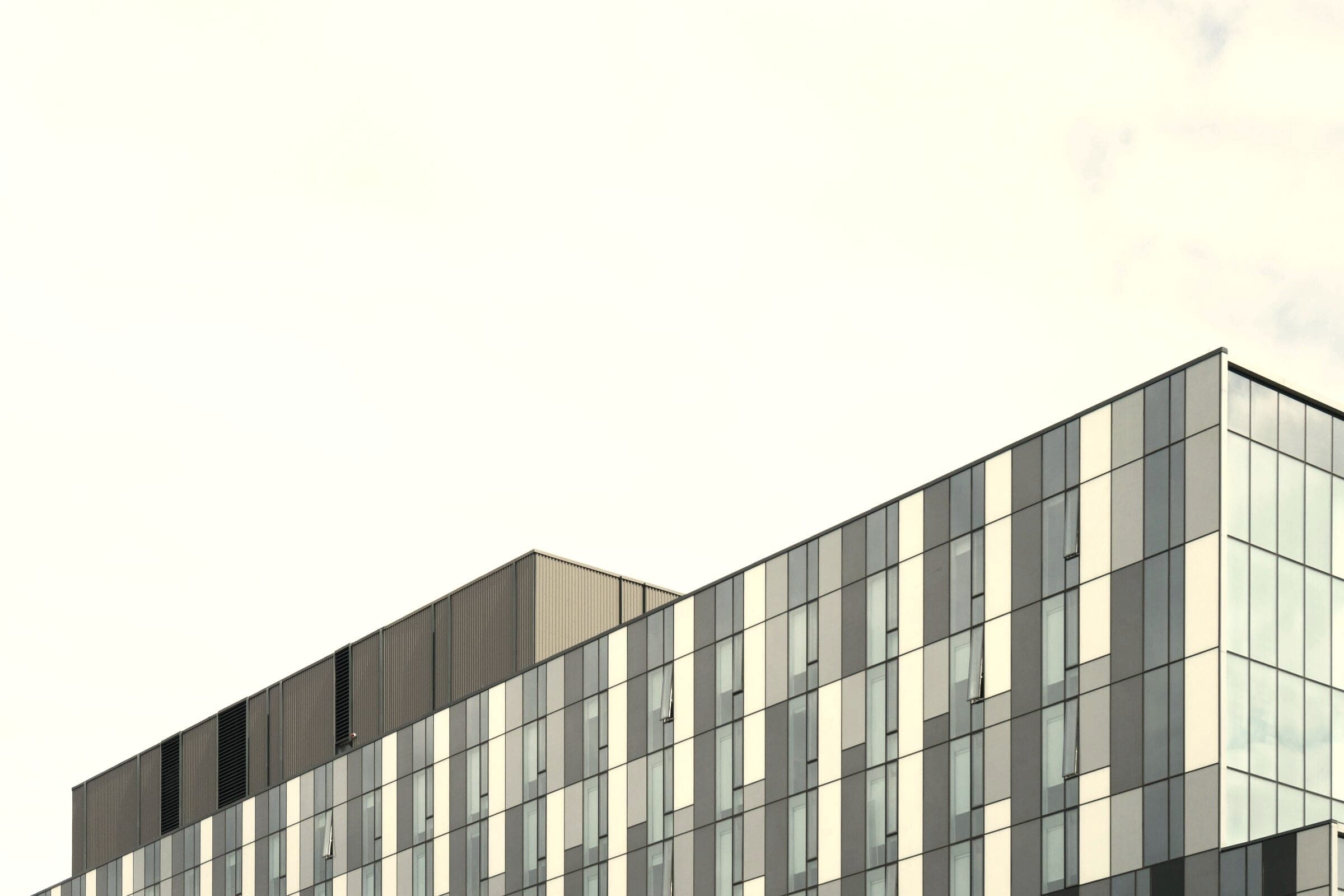 Building roofline beneath a wide open sky